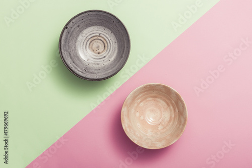 two asian bowl on the color(green, pink) paper background.