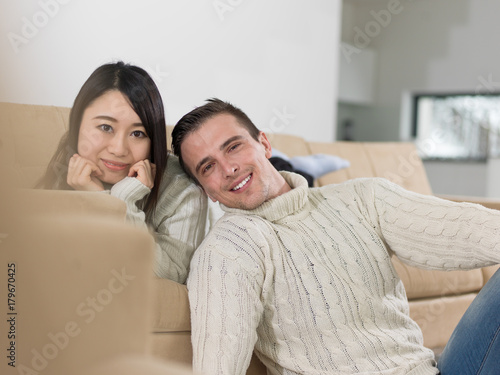 happy multiethnic couple relaxing at home