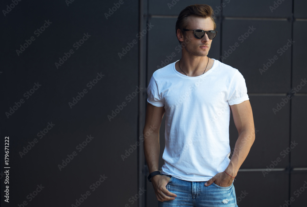 Street fashion concept. Portrait of a young and handsome man in a white ...