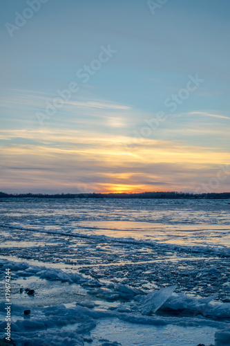 Sunset over frozen river Volga