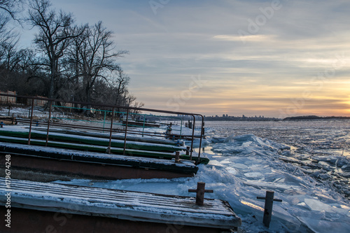 Sunset over frozen river and pier near Samara city