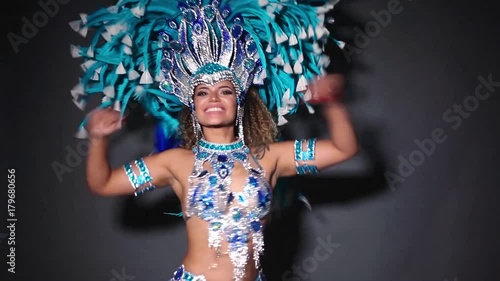Beautiful and happy woman dancing samba while wearing traditional costume photo
