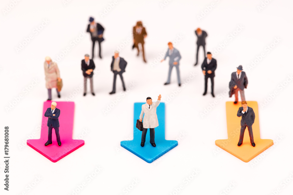 Miniature people,Businessman leader standing on arrow to select way go ahead,business concept Miniature people,Businessman leader standing on arrow to select way go ahead,business concept