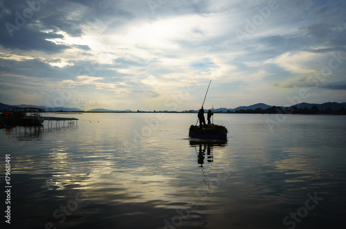 Vietnam landscape. Lake with a boat made of canvas sheet to carry harvested rice at sunset