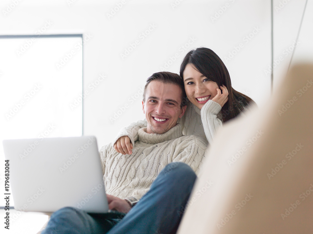 multiethnic couple using laptop computers multiethnic couple using laptop computers