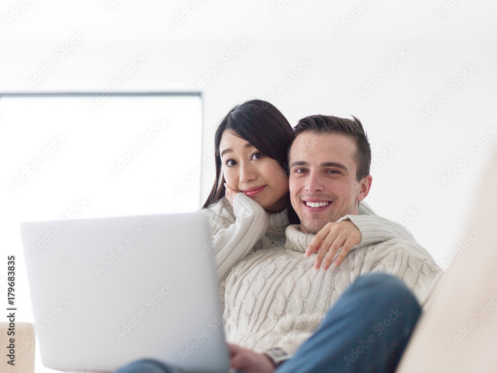 multiethnic couple using laptop computers multiethnic couple using laptop computers