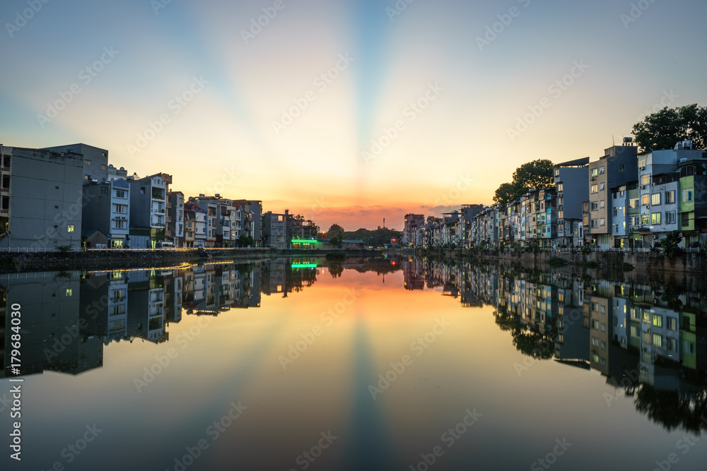 Naklejka premium Hanoi cityscape at sunset. Resident buildings by Tien Bien lake, Gia Lam district