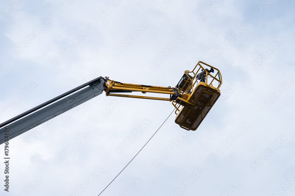 Cameraman on a crane, filming at a sporting event... Cameraman on a crane, filming at a sporting event...