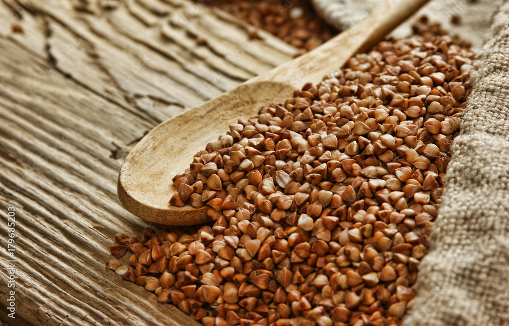buckwheat groats and wooden spoon buckwheat groats and wooden spoon