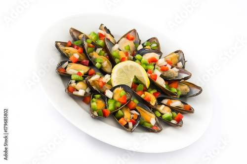 Steamed mussels with peppers and onion isolated on white background

