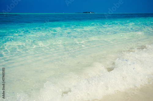Exotic tropical beach. Summer vacation and tourism, popular destination, luxury travel concept. Maldives, Indian Ocean. Seascape with white sand, crystal clear turquoise water. Paradise holiday island