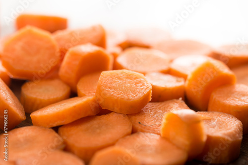 Pile of sliced and chopped carrot on the wooden board