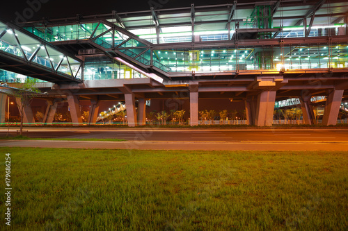Empty green grass with viaduct bridge of night © Aania