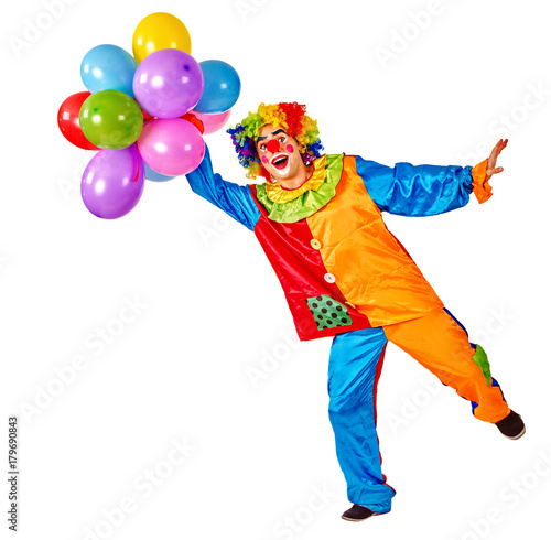 Birthday child clown with balloons bunch on isolated. Events organizer man is standing on one leg on white background. Organization of children's parties.