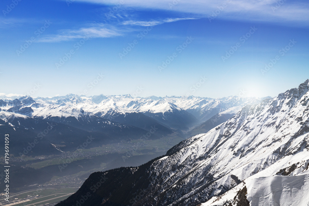 Bright sunlight in snowy mountain valley