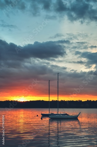 Beautiful summer evening landscape. Boats on the lake at sunset.