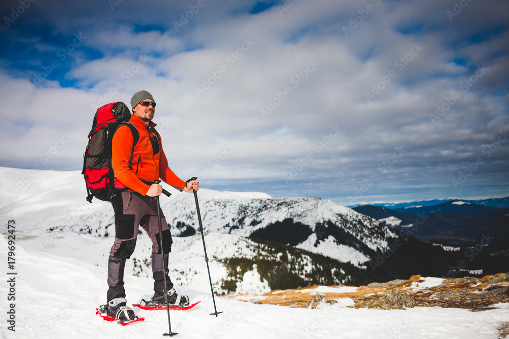 Male tourist in snow snowshoes. Male tourist in snow snowshoes.