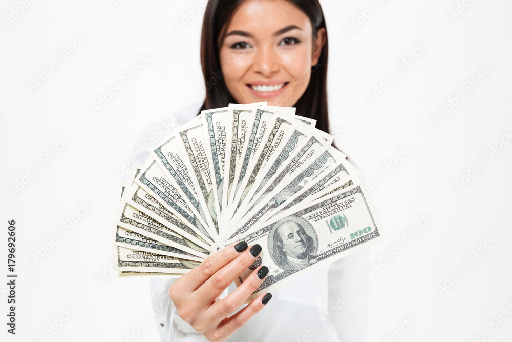Smiling young asian woman holding money. Smiling young asian woman holding money.