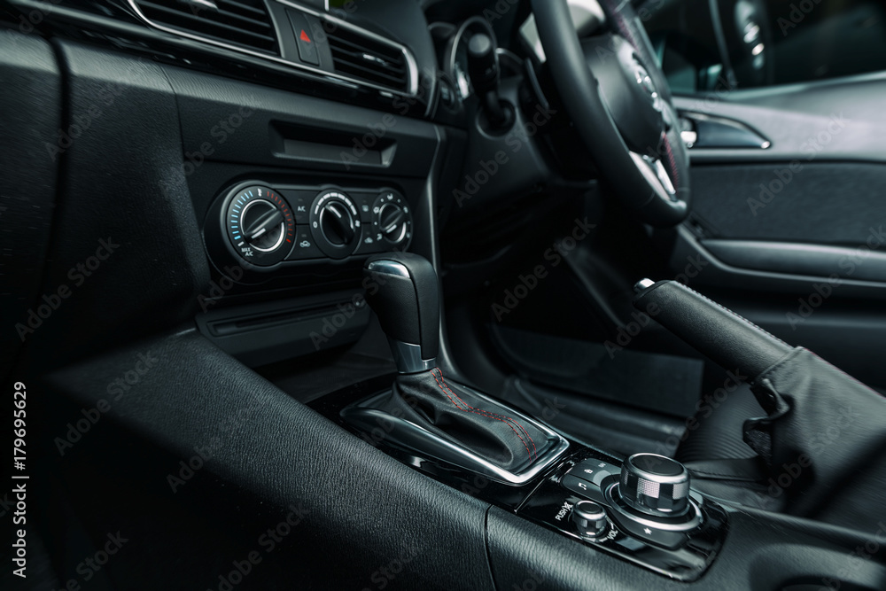 Modern car gear stick, handbrake and wheel Modern car gear stick, handbrake and wheel