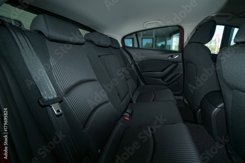 Modern car interior with back seat, front seats and belts © jaaske