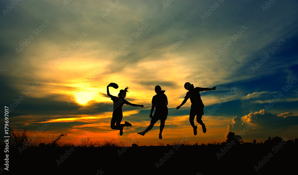 Silhouette of a three girls jumping, look like they can flying.