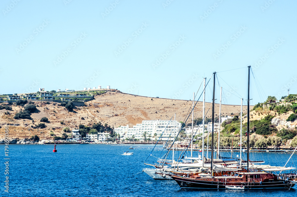 Yachts in the Bay of Bodrum, Turkey. In the background there are windmills on the hill.