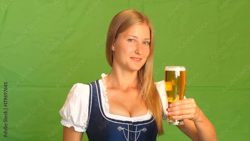 Woman in bavarian costume laughs and shows thumbs up. Green screen Woman in bavarian costume laughs and shows thumbs up. Green screen