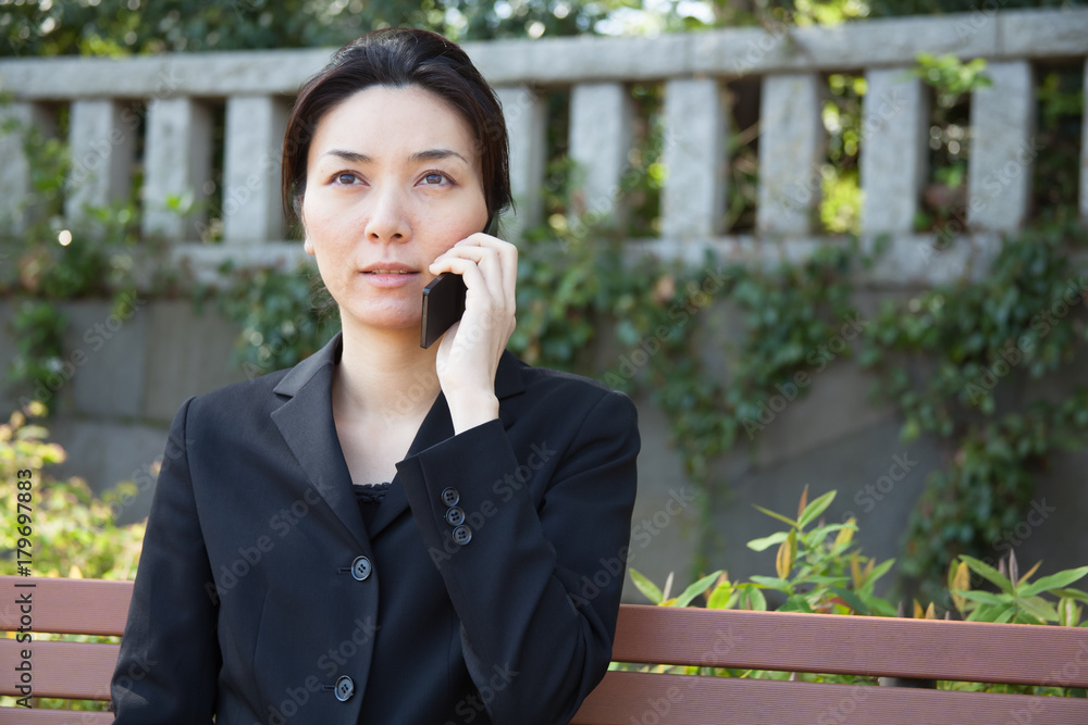Japanese Business Woman Talking on Mobile Phone Japanese Business Woman Talking on Mobile Phone