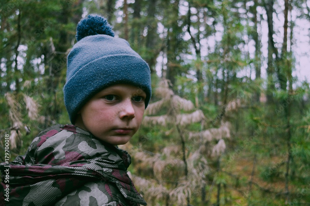 The boy, walking in the woods heard something and looked around The boy, walking in the woods heard something and looked around