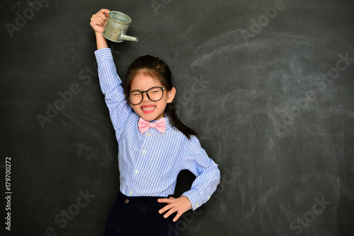 beautiful pretty little girl using watering bottle
