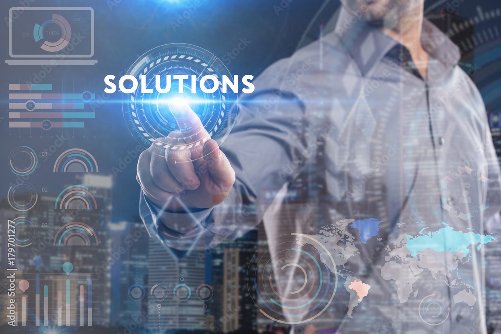 Business, Technology, Internet and network concept. Young businessman working on a virtual screen of the future and sees the inscription: Solutions Business, Technology, Internet and network concept. Young businessman working on a virtual screen of the future and sees the inscription: Solutions