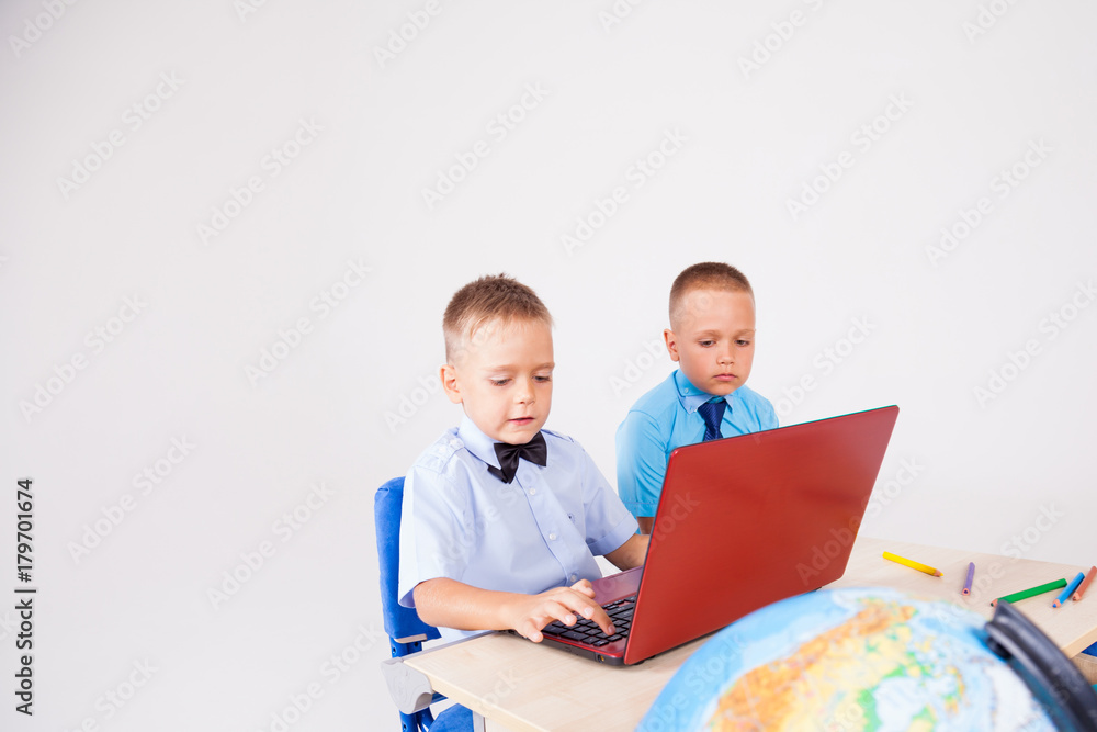 two boys sit at the computer training school two boys sit at the computer training school