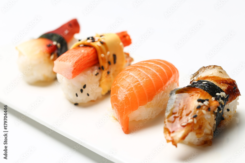 assorted sushi on white plate isolated on white back ground assorted sushi on white plate isolated on white back ground