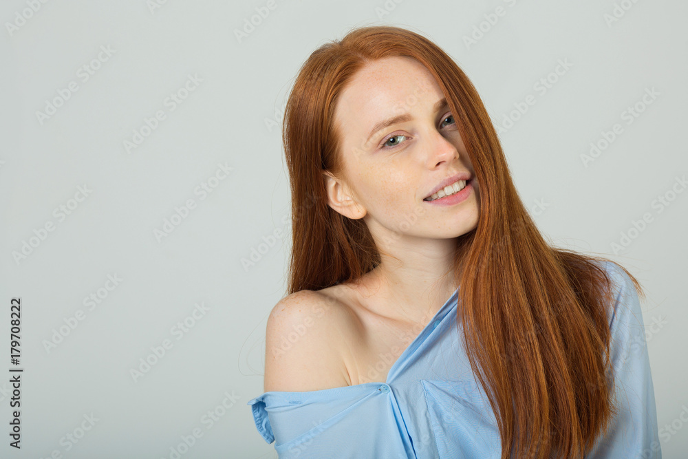 beautiful young girl with red hair with bare shoulder on a light background beautiful young girl with red hair with bare shoulder on a light background