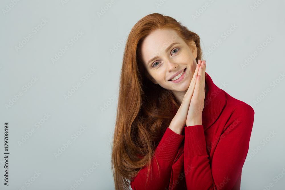 beautiful young smiling girl with red hair in a red sweater on a light background beautiful young smiling girl with red hair in a red sweater on a light background