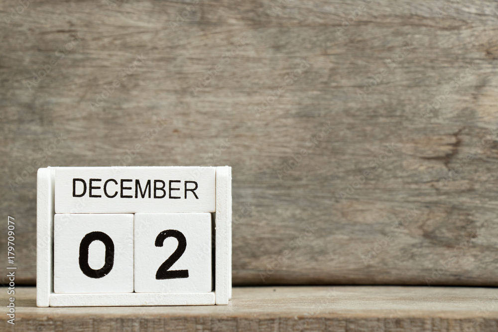 White block calendar present date 2 and month December on wood background White block calendar present date 2 and month December on wood background