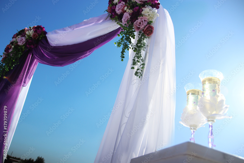 wedding arch and glasses against the background of water wedding arch and glasses against the background of water