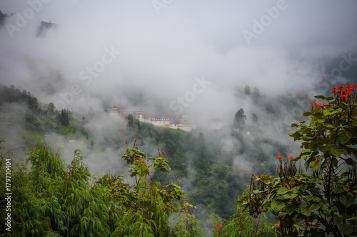 View of Trongsa Dzong with foggy hills, Bumthang, Bhutan.