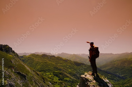 Man on mountain at dawn.
