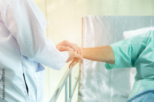 Doctor give moral to old patient photo