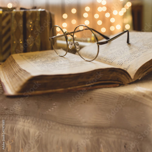 Holy bible book with eyeglasses