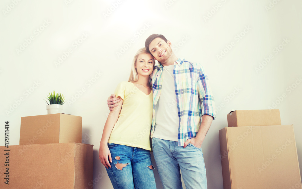 smiling couple with big boxes moving to new home smiling couple with big boxes moving to new home