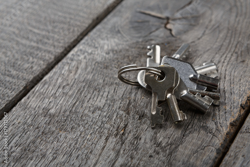 Set of new metal keys on aged wood