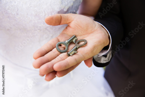 Wedding keys in bride and groom hands