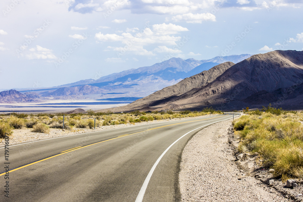 One of the roads that crosses Death Valley National Park, a desert valley located in Eastern California and one of the hottest places in the world One of the roads that crosses Death Valley National Park, a desert valley located in Eastern California and one of the hottest places in the world