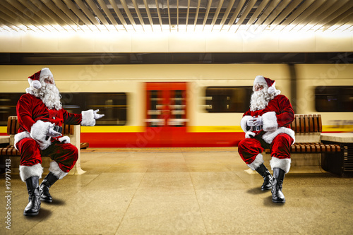 The trip of Santa Claus. Old man waiting for a train in the subway. A fast train on the background.
