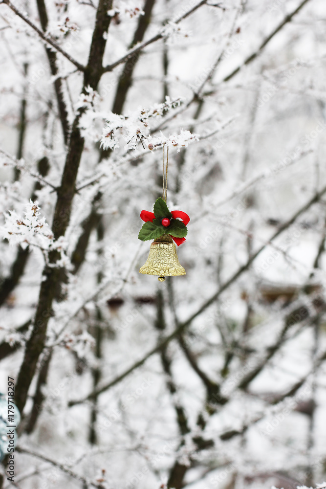 Christmas toys hanging on the tree. First snow. This tree outside in the snow. New Year. Christmas. Snow. Frost. White. Red Christmas toys hanging on the tree. First snow. This tree outside in the snow. New Year. Christmas. Snow. Frost. White. Red