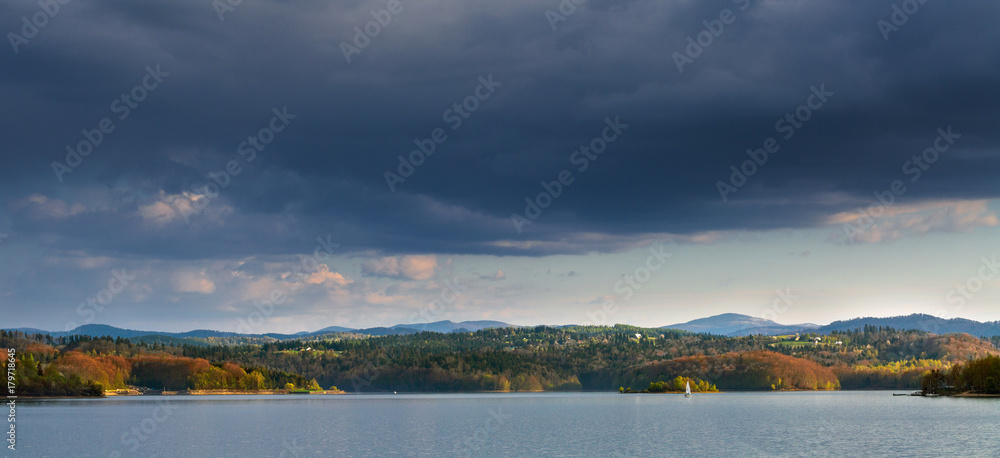 Solina Lake is a Poland's largest artificial lake in the Bieszczady Mountains. Autumn evening sunlight.