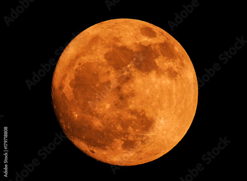 The yellow full moon on black background photo