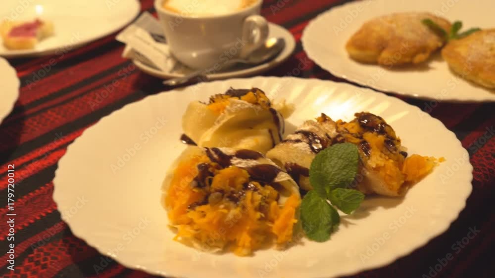on a white big plate lies a portion of pumpkin pancakes. beautiful serving of food in the restaurant. 4 k on a white big plate lies a portion of pumpkin pancakes. beautiful serving of food in the restaurant. 4 k